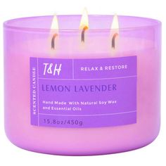 a pink candle with three candles in it and the words lemon lavender written on top