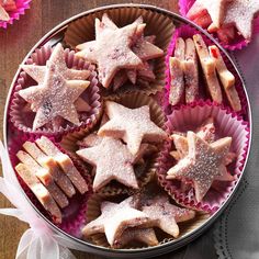 star shaped cookies in pink tins on a table