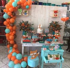 an orange and blue balloon arch in the middle of a room