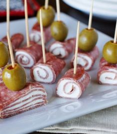 small appetizers with olives are arranged on a plate