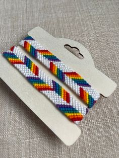 two colorful bracelets sitting on top of a table