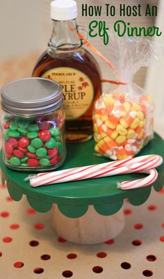 a table topped with jars filled with candy and candies on top of a green tray