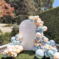 a large white and blue sculpture sitting in the grass