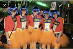 a group of people that are standing in front of each other with blue hair and costumes