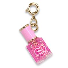 a pink bottle with a heart on it is hanging from a gold keychain