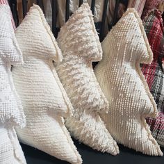 several decorative pillows are lined up on a table