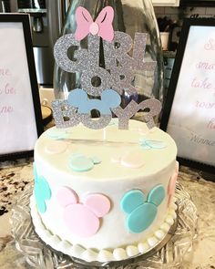 a cake with minnie mouse decorations on top and two signs behind it that say happy birthday