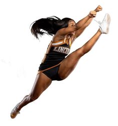 a female cheerleader is jumping in the air with her arms out and legs spread wide