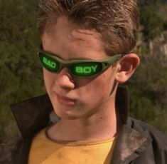 a young boy wearing sunglasses with the word yob on it's side and glowing green eyes