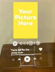 a wooden table topped with a glass display case filled with musical instruments and a yellow sign that says your picture here