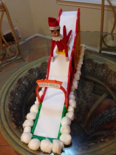 an elf on a sled made out of toilet paper