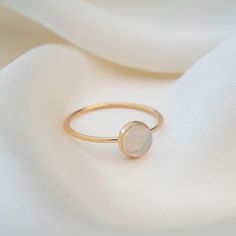 Featuring a stunning 5mm hand picked Australian Opal. Each stone is unique and since these are natural Opals, no two stones will ever be alike. This ring is handmade with a 14k Gold filled ring and a stunning natural opal set in a gold filled bezel. Material: 14k Gold filled Natural Australian Opal Adjustable 14k Gold Rings With Round Stone, Everyday Opal Jewelry With Gemstones, Everyday Opal Gemstone Jewelry, Adjustable Opal Birthstone Ring For Everyday, Minimalist Everyday Opal Jewelry, Classic Ethiopian Opal Gemstone Rings, Minimalist Yellow Gold Moonstone Ring In Sterling Silver, Minimalist Yellow Gold Sterling Silver Moonstone Ring, Fine Jewelry Opal Ring With Round Stone For Gift