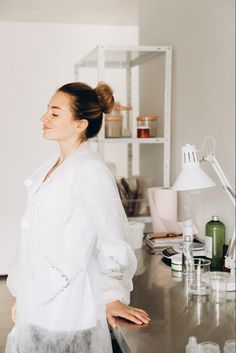 a woman standing in front of a counter