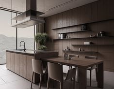 a kitchen with a table and chairs next to an open window overlooking the mountain range