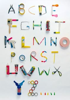 the letters and numbers are made out of crayon pencils, scissors, glue, tape, and other items