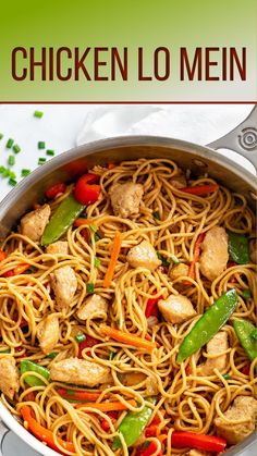 chicken lo mein in a skillet with peppers, carrots and green onions on the side