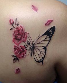 a woman's back with pink roses and a butterfly tattoo on her left side