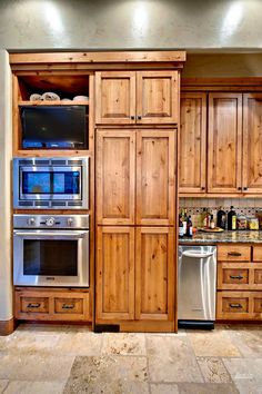 a kitchen with wooden cabinets and stainless steel appliances