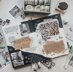 an open scrapbook sitting on top of a table covered in paper and other items