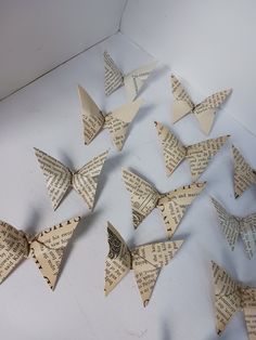 many origami butterflies made out of old book pages