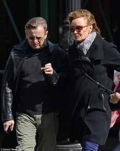 a man and woman walking down the street