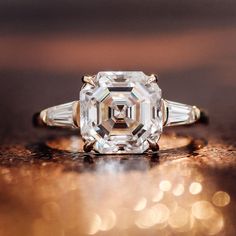 an old cut diamond ring sitting on top of a table