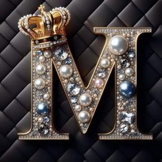 the letter m with pearls and a crown on it's head is shown in gold