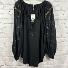 Free People Peasant Top 3/4 Sleeve Details Lace Up Tassel Tie V-Neck Black S Nwt A Beautiful Oversized Tunic-Length Top From Free People New With Tags. Tie Tassels For Lace Up Detailing At The Neckline. Gold Embellishments On The Sleeves And End Of Tassels. Lightweight And Flowy Silhouette That Is Sure To Become A Staple In Your Wardrobe. Condition: Nwt Brand: Free People Size: S Color: Black Material: 100% Rayon Approximate Measurements (Garment Laying Flat)- Pit To Pit: 23” Length: 28” Sleeve Casual V-neck Peasant Top With Tassels, Bohemian Peasant Top With Tassel Ties V-neck, Long Sleeve Black Peasant Top For Fall, Fall Long Sleeve Tops With Tassel Ties, Casual Long Sleeve Peasant Top With Tassel Ties, Fall Long Sleeve Blouse With Tassel Ties, Black Long Sleeve Peasant Top For Fall, Black Long Sleeve Peasant Top For Festival, Black Peasant Top For Fall