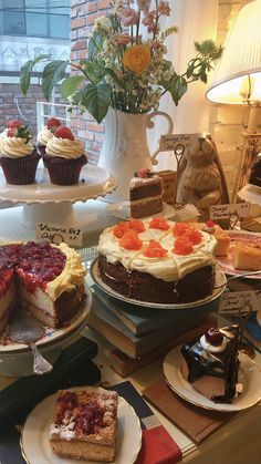 several cakes and desserts on display at a bakery