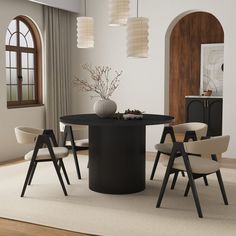 a dining room table with four chairs around it