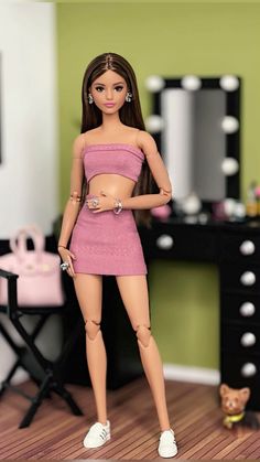 a barbie doll standing in front of a dressing table