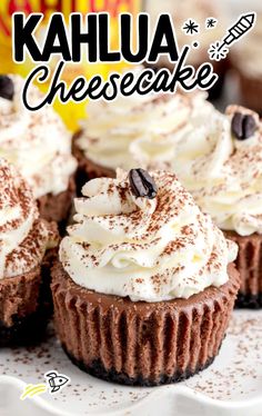 chocolate cupcakes topped with whipped cream and chocolate chips on a white platter