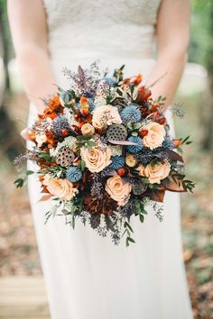 a bride holding a bouquet of flowers in her hands