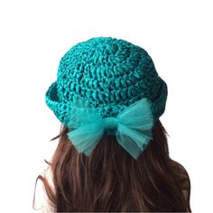 a woman's head wearing a green hat with a bow on it and the back of her head