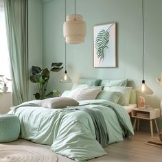 a bedroom with light green walls and bedding in the corner, along with plants