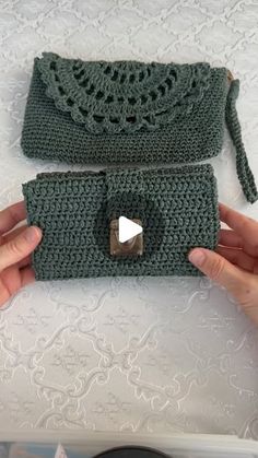 a hand holding a green crocheted purse