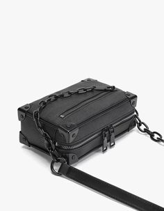 Meet your new go-to accessory: the Crossbody Box Bag with Attached Chain Detail, where style meets practicality.

Crafted with an edgy mix of textures and a thoughtfully designed pattern, this bag is made for those who appreciate a touch of moody sophistication. The exterior boasts a durable, grainy finish complemented by a bold chain detail, offering a juxtaposition of nonchalance and polish. Inside, the bag features a neatly organized compartment with a dedicated space to secure your essential Rectangular Box Bag With Chain, Rectangular Chain Box Bag, Rectangular Bags With Hardware As Fashion Accessory, Chic Rectangular Box Bag With Chain, Trendy Rectangular Shoulder Bag With Hardware, Square Box Bag With Chain For Everyday Use, Elegant Rectangular Bag With Hardware Details, Evening Bags With Hardware In Rectangular Shape, Modern Travel Bag With Chain Detail