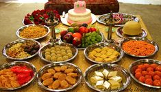 a table topped with lots of different types of foods and desserts next to each other