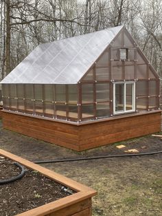 a small house with a metal roof in the woods