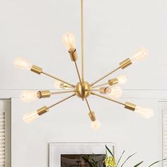 a chandelier hanging from the ceiling in a room with white walls and windows