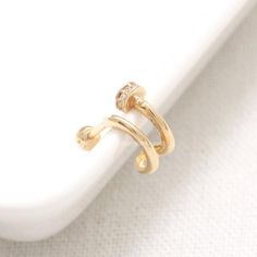 two gold rings sitting on top of each other