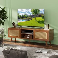 a flat screen tv sitting on top of a wooden entertainment center in a living room