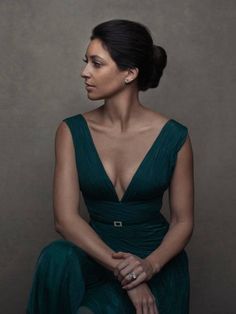 a woman in a green dress sitting down