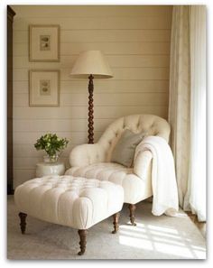 a white chair and ottoman in a room