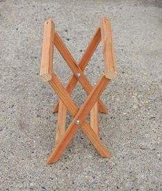 a small wooden bench sitting on top of a cement ground