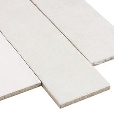 two white tiles laying next to each other on top of a white flooring board