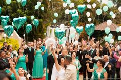 a group of people that are standing in front of some balloons