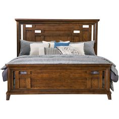 a bed with wooden headboard and foot board on top of it, sitting against a white background