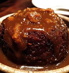 a close up of a plate of food with meat and gravy on it