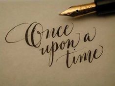 the words once upon a time written in cursive writing with a fountain pen